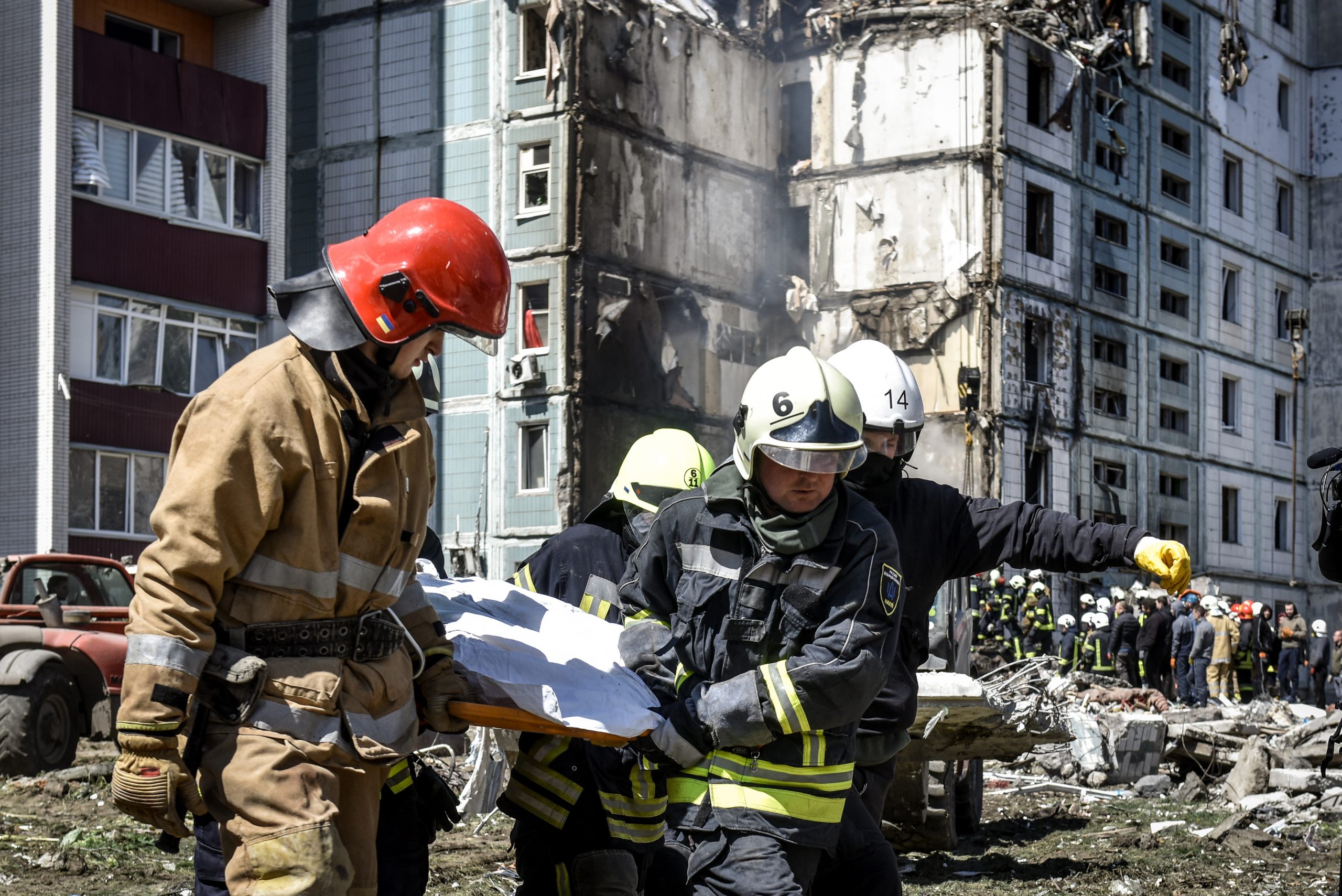 epa10596608 Rescuers carry a body recovered at the site of a damaged residential building after a missile attack, in Uman, Cherkasy region, central Ukraine, 28 April 2023. At least 17 people were killed as a result of a rocket attack in Uman, and 18 others were injured, according to the State Emergency Service of Ukraine. Ukraine's Ministry of Internal Affairs said on 28 April, that the Russian army conducted attacks on residential buildings across the country, including Dnipro, Uman and Ukrainka in the Kyiv region.  EPA/OLEG PETRASYUK