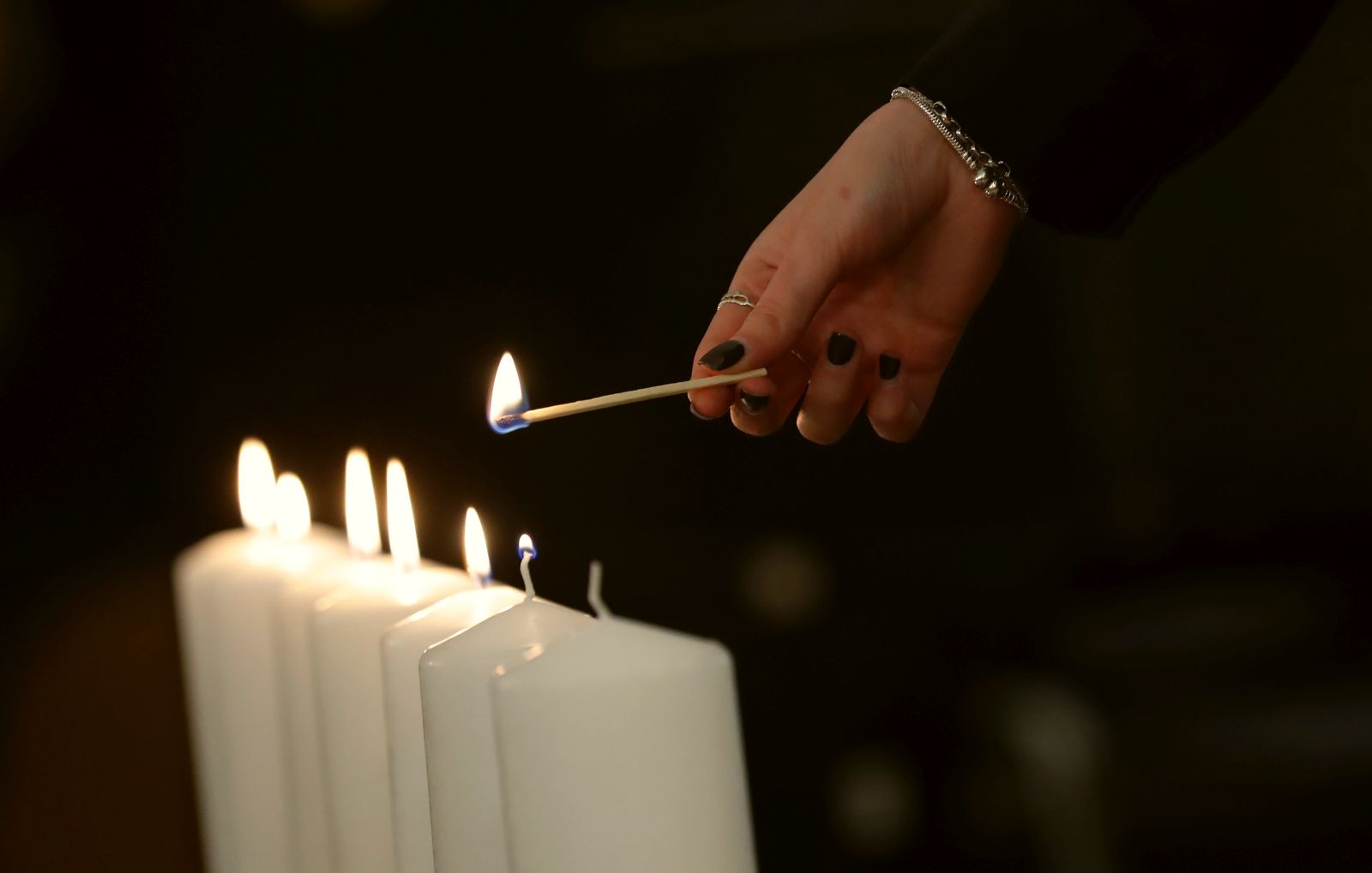 epa10578896 A person lights a candle during a special memorial service for victims of the Holocaust during the celebration of Yom HaShoah, the Israeli Holocaust Remembrance Day, at the Jewish Community Center in Bucharest, Romania, 18 April 2023. The Holocaust Remembrance Day 2023 began in the morning of 17 April and will end in the evening of 18 April, corresponding to the 27th day of Nisan on the Hebrew calendar, also marking the anniversary of the Warsaw Ghetto Uprising during World War II.  EPA/ROBERT GHEMENT