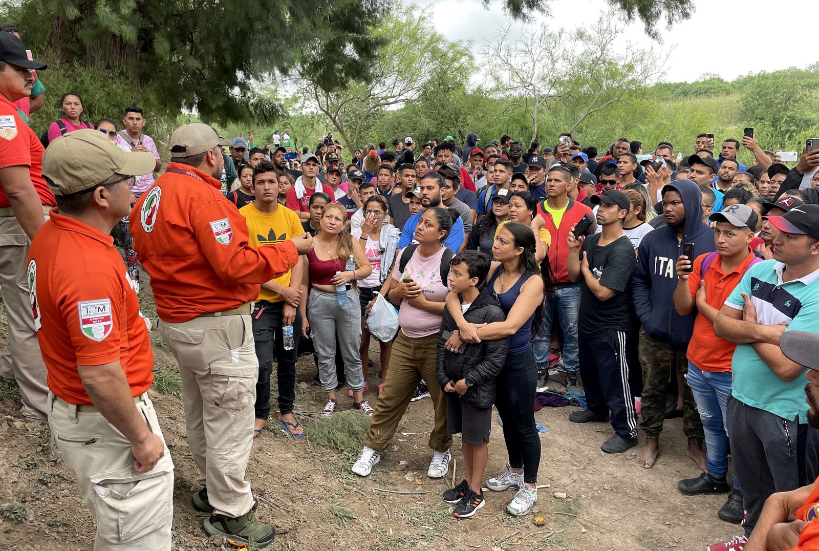 epa10590014 Members of the National Institute of Migration (INM) of Mexico speak with a group of immigrants to discourage them from crossing the Rio Grande river, in Matamoros, Mexico, 24 April 2023. Agents  warned thousands of migrants not to cross the waters of the Rio Grande but hundreds from Central and South America crossed to the US to turn themselves in to the US Border Patrol.  EPA/Abraham Pineda-Jacome