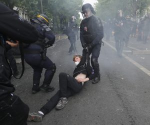 epa10602424 French police officers detain a protester during clashes at the annual May Day march in Paris, France, 01 May 2023. Despite the Constitutional Council's adoption of the law on 14 April raising the retirement age in France from 62 to 64 years old, protests against pension reform are being held in France on this International Workers' Day. Following the filing of a new appeal by the left-wing senators, a new decision is expected on 03 May.  EPA/TERESA SUAREZ