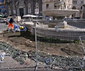 epa10609909 Municipal workers clean up the wrought iron fence that borders the 'Carciofo' fountain in Piazza Trieste e Trento which was damaged during the night's celebrations of winning the Serie A league title, in Naples, Italy, 05 May 2023. Napoli the previous evening clinched the Scudetto with five games to spare after the away match result gave them an unassailable 16-point lead at the top of the table. It was the third Italian championship title in the history of the Naples side, and their first since 1990, when late soccer great Diego Maradona played for them.  EPA/CIRO FUSCO