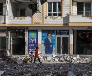 epa10610834 People walk in front of a picture of Turkish oppoisiton IYI Parti party leader Meral Aksener in Nurdagi district of Gaziantep, Turkey, 05 May 2023. More than 50,000 people died and thousands more were injured after major earthquakes struck southern Turkey and northern Syria on 06 February and again on 20 February 2023.  EPA/ERDEM SAHIN