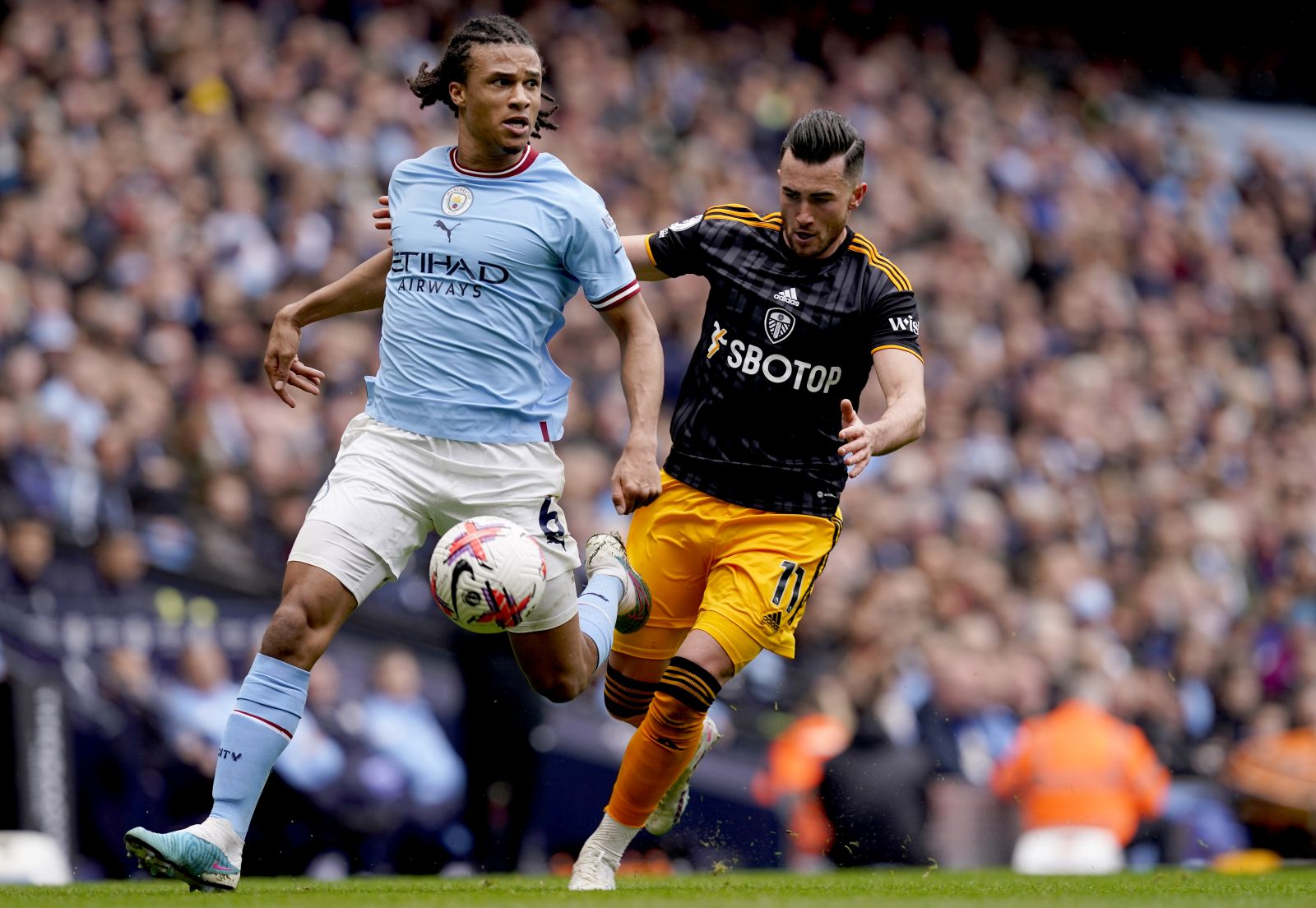 epa10612226 Nathan Ake (L) of Manchester City and Jack Harrison of Leeds in action during the English Premier League match between Manchester City and Leeds United, in Manchester, Britain, 06 May 2023.  EPA/TIM KEETON EDITORIAL USE ONLY. No use with unauthorized audio, video, data, fixture lists, club/league logos or 'live' services. Online in-match use limited to 120 images, no video emulation. No use in betting, games or single club/league/player publications.