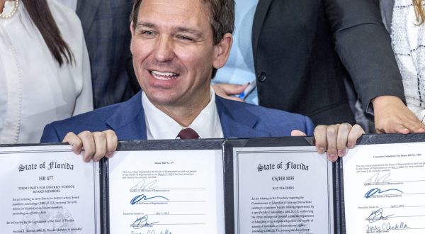 epa10617724 Florida Governor Ron DeSantis (C) show the documents after he signed the Teacher's Bill of Rights during an event at True North Classical Academy in Miami, Florida, USA, 09 May 2023. According to DeSantis Tweeter account, during the event he signed legislations to Protects teacher paychecks from automatic union deductions, to Creates a Teachers' Bill of Rights, to Reforms school board elections and to Removes social media from classrooms, in addition to approving a $1 billion for teacher salaries.  EPA/CRISTOBAL HERRERA-ULASHKEVICH