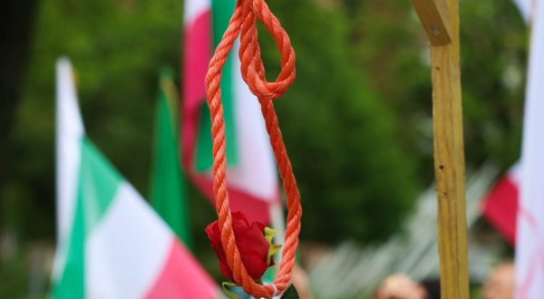 epa10623184 A rose hangs on gallows during a protest by representatives of opposition group the National Council of Resistance of Iran (NCRI) in front of Iranian embassy in Brussels, Belgium, 12 May 2023. According to the NCRI, the protesters are demanding the closure of the Iranian embassy.  EPA/OLIVIER HOSLET