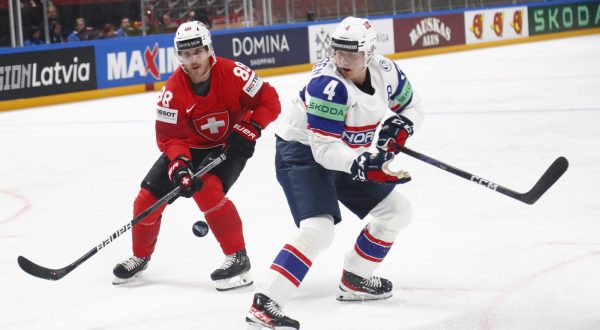 epa10627355 Johannes Johannesen (R) of Norway and Christoph Bertschy of Switzerland in action during the preliminary round group B match between Norway and Switzerland at the IIHF Ice Hockey World Championship 2023 in Arena Riga, Latvia, 14 May 2023.  EPA/TOMS KALNINS