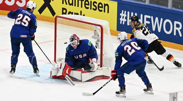 epa10629745 Samuel Soramies (R) from Germany and (L-R) Nick Perbix, Casey Desmith and Lane Hutson from USA in action during the IIHF 2023 Ice Hockey World Championship first round group A match between Germany and USA in Tampere, Finland, 15 May 2023.  EPA/KIMMO BRANDT
