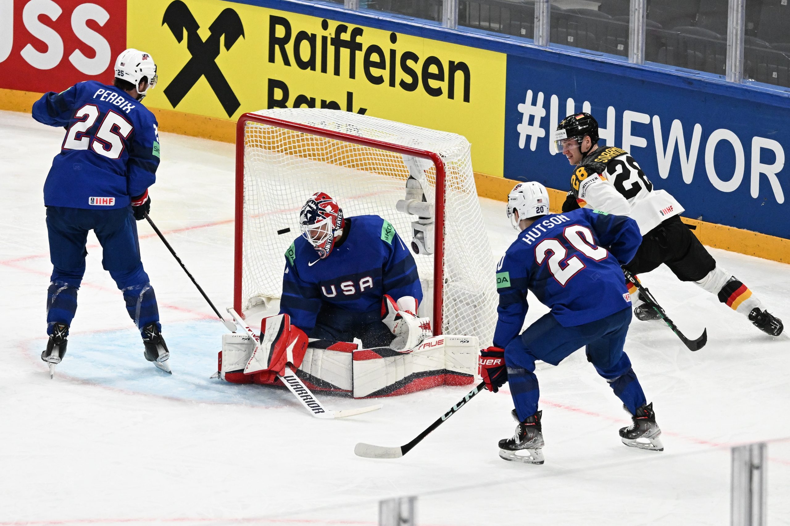 epa10629745 Samuel Soramies (R) from Germany and (L-R) Nick Perbix, Casey Desmith and Lane Hutson from USA in action during the IIHF 2023 Ice Hockey World Championship first round group A match between Germany and USA in Tampere, Finland, 15 May 2023.  EPA/KIMMO BRANDT