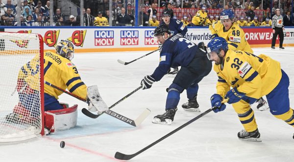 epa10630042 Goalkeeper Lars Johansson (L)  and Lukas Bengtsson (R) from Sweden and Olli Maatta from Finland in action during the IIHF 2023 Ice Hockey World Championship first round group A match between Sweden and Finland in Tampere, Finland, 15 May 2023  EPA/KIMMO BRANDT