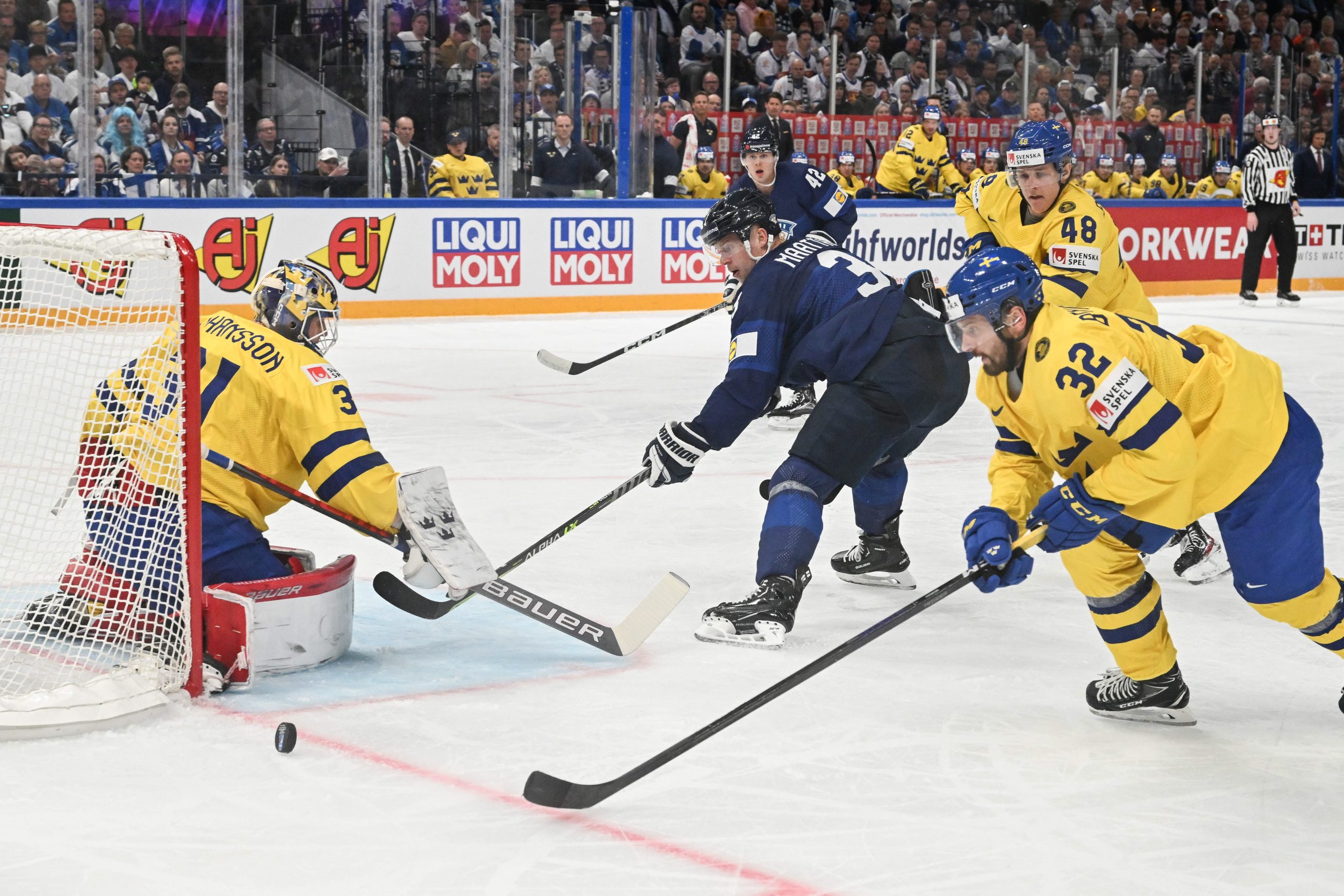 epa10630042 Goalkeeper Lars Johansson (L)  and Lukas Bengtsson (R) from Sweden and Olli Maatta from Finland in action during the IIHF 2023 Ice Hockey World Championship first round group A match between Sweden and Finland in Tampere, Finland, 15 May 2023  EPA/KIMMO BRANDT