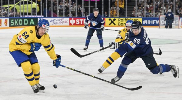 epa10630038 Jonathan Pudas (L) from Sweden and Sakari Manninen from Finland in action during the IIHF 2023 Ice Hockey World Championship first round group A match between Sweden and Finland in Tampere, Finland, 15 May 2023  EPA/KIMMO BRANDT