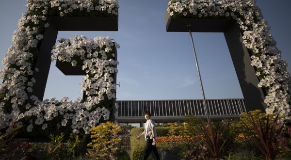 epa10633821 A woman walks past a G7 flower installation ahead of the G7 Summit at the Hiroshima Peace Memorial Park in Hiroshima, Japan, 17 May 2023. The G7 Hiroshima Summit will be held from 19 to 21 May 2023.  EPA/HOW HWEE YOUNG