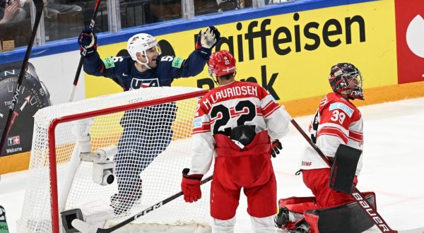 epa10640465 Rocco Grimaldi (L) from USA celebrates a goal during the IIHF 2023 Ice Hockey World Championship group A match between USA and Denmark in Tampere, Finland, 20 May 2023.  EPA/KIMMO BRANDT