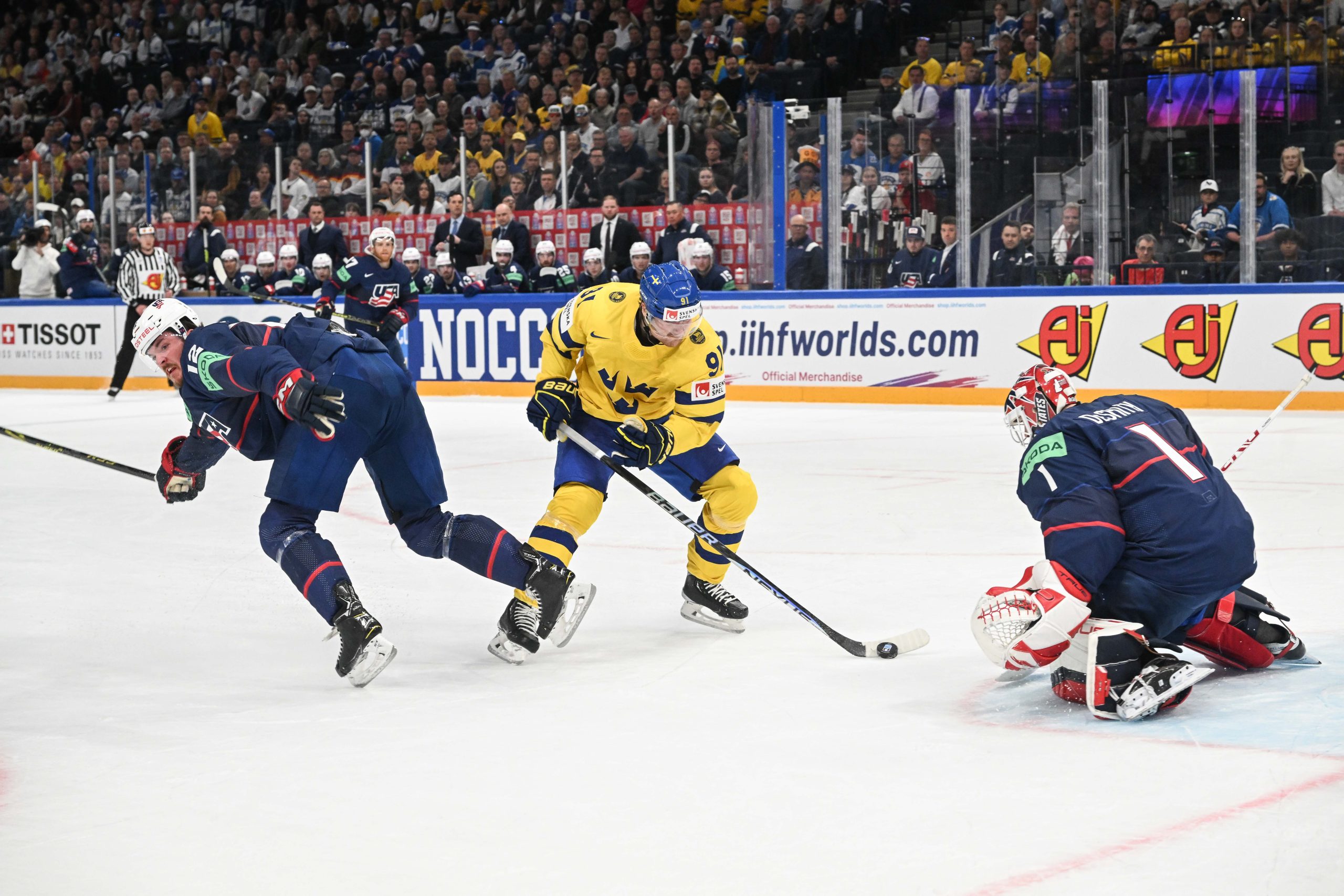 epa10647929 Carl Grundstrom (C) from Sweden and Dylan Samberg (L) and Cassey DeSmith (R) from USA in action during the IIHF 2023 Ice Hockey World Championship group A match between Sweden and USA in Tampere, Finland, 23 May 2023  EPA/KIMMO BRANDT