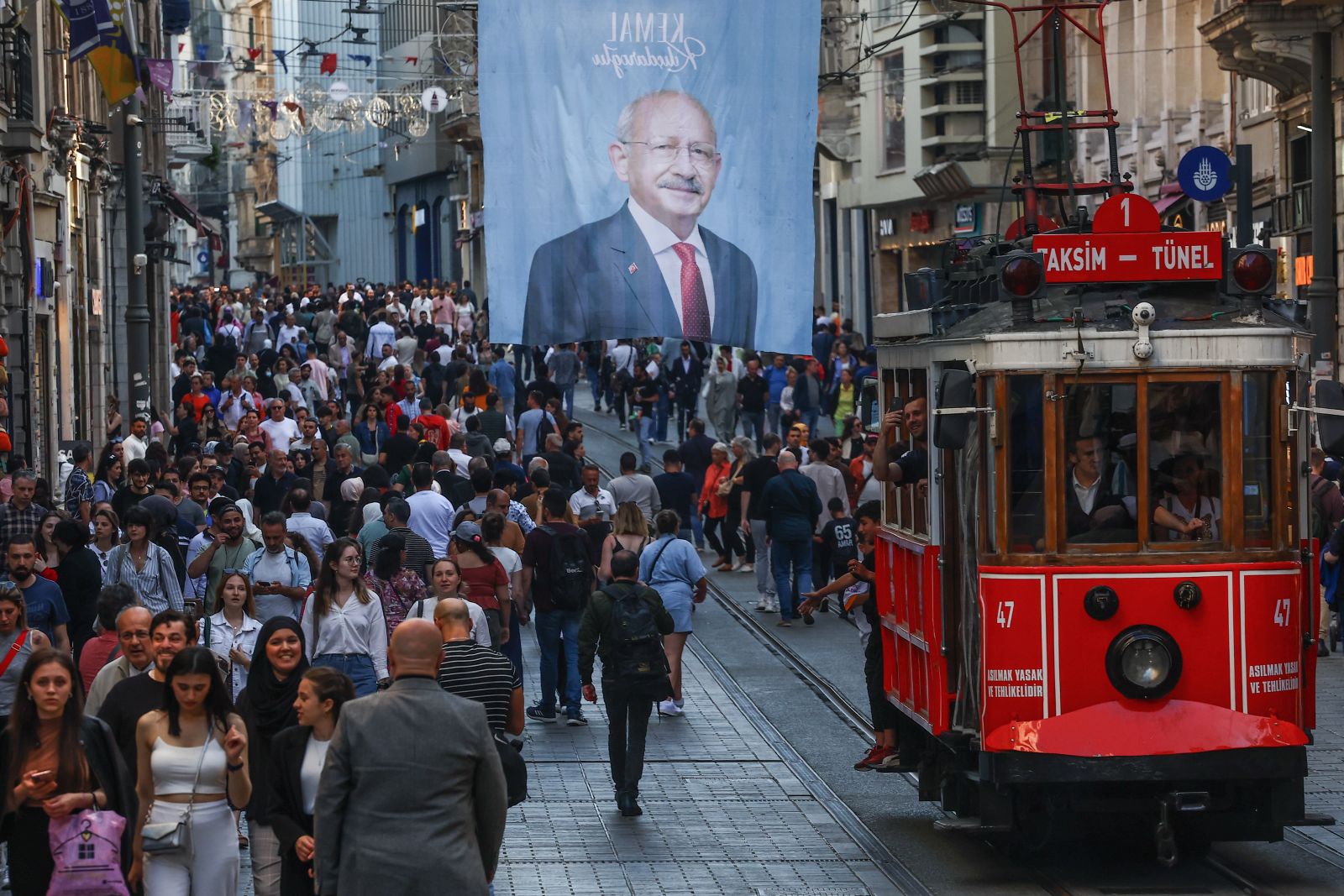 epaselect epa10655861 The nostalgic tram passes under an election campaign poster of Turkish presidential candidate Kemal Kilicdaroglu, leader of the opposition Republican People's Party (CHP), at Istiklal Street in Istanbul, Turkey, 26 May 2023. General elections had been held in Turkey on 14 May, where none of the candidates exceeded the 50 percent mark in the first round. The second round of presidential elections between Turkish President Recep Tayyip Erdogan and his challenger Kemal Kilicdaroglu, the leader of the opposition Republican People's Party (CHP), will be held on 28 May.  EPA/SEDAT SUNA