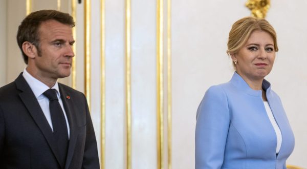 epa10664392 Slovak President Zuzana Caputova (R) and French Presiden Emmanuel Macron (L) arrive for a meeting at the Grassalkovich Palace, official seat of the Slovak President, in Bratislava, Slovakia, 31 May 2023.  EPA/CHRISTIAN BRUNA