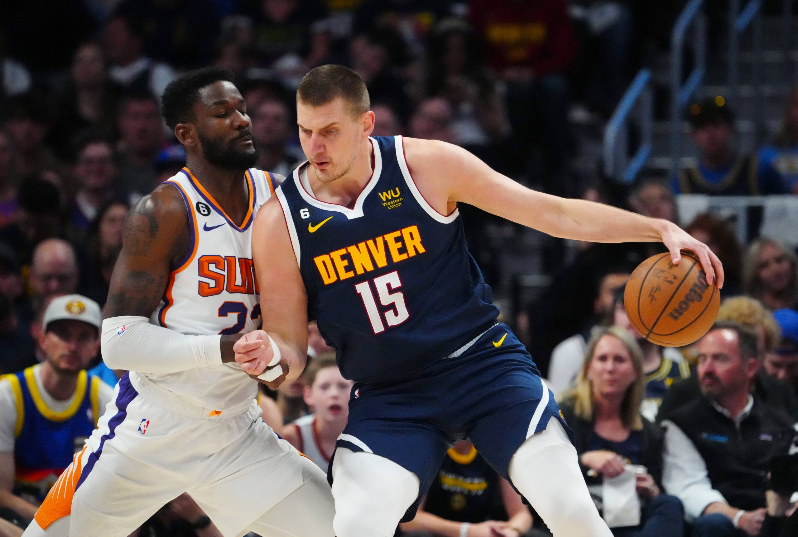 May 1, 2023; Denver, Colorado, USA; Denver Nuggets center Nikola Jokic (15) drives at Phoenix Suns center Deandre Ayton (22) in the first quarter during game two of the 2023 NBA playoffs at Ball Arena. Mandatory Credit: Ron Chenoy-USA TODAY Sports Photo: Ron Chenoy/REUTERS