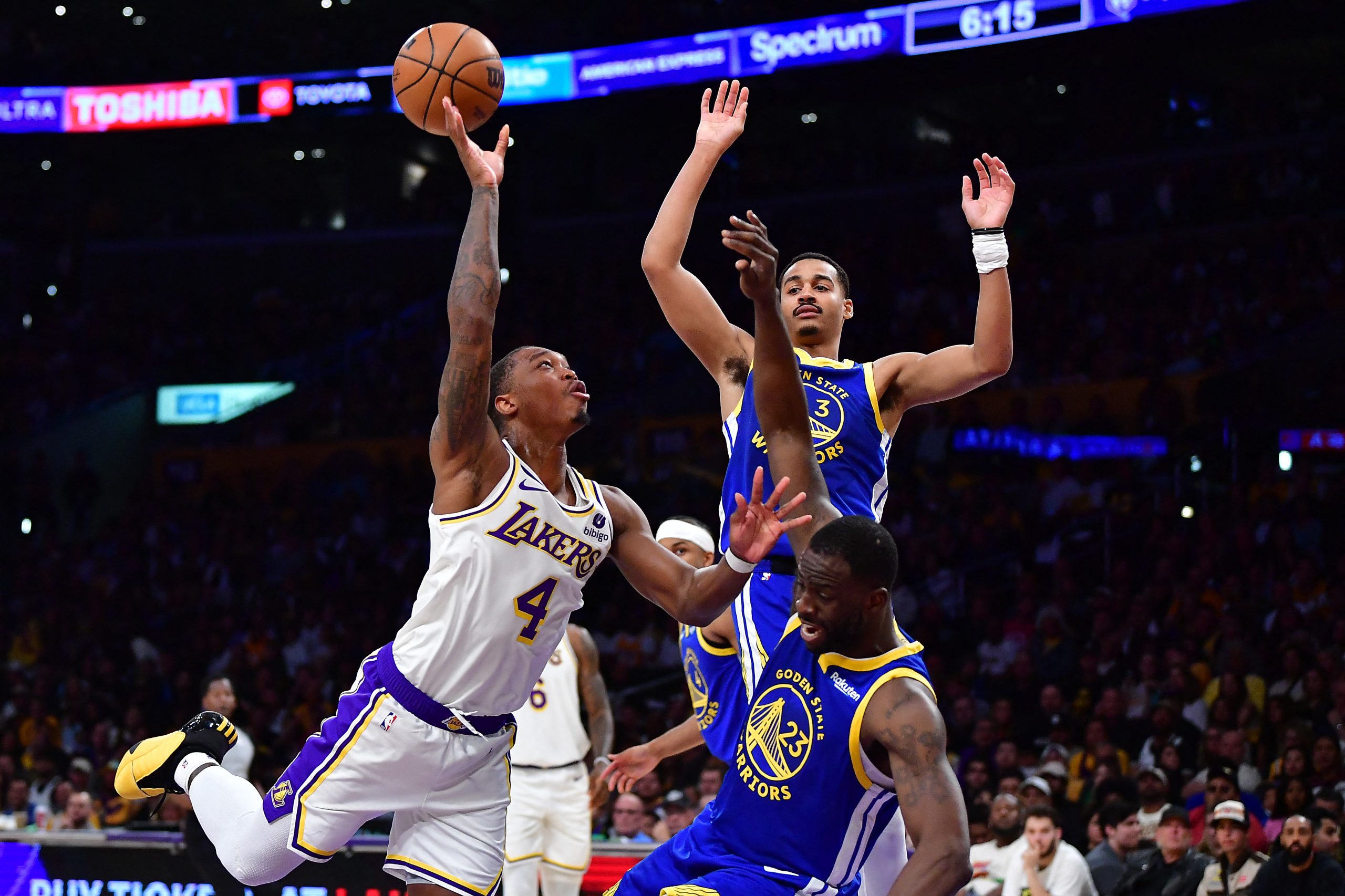 May 6, 2023; Los Angeles, California, USA; Los Angeles Lakers guard Lonnie Walker IV (4) shoots against Golden State Warriors guard Jordan Poole (3) and forward Draymond Green (23) during the first half in game three of the 2023 NBA playoffs at Crypto.com Arena. Mandatory Credit: Gary A. Vasquez-USA TODAY Sports Photo: Gary A. Vasquez/REUTERS