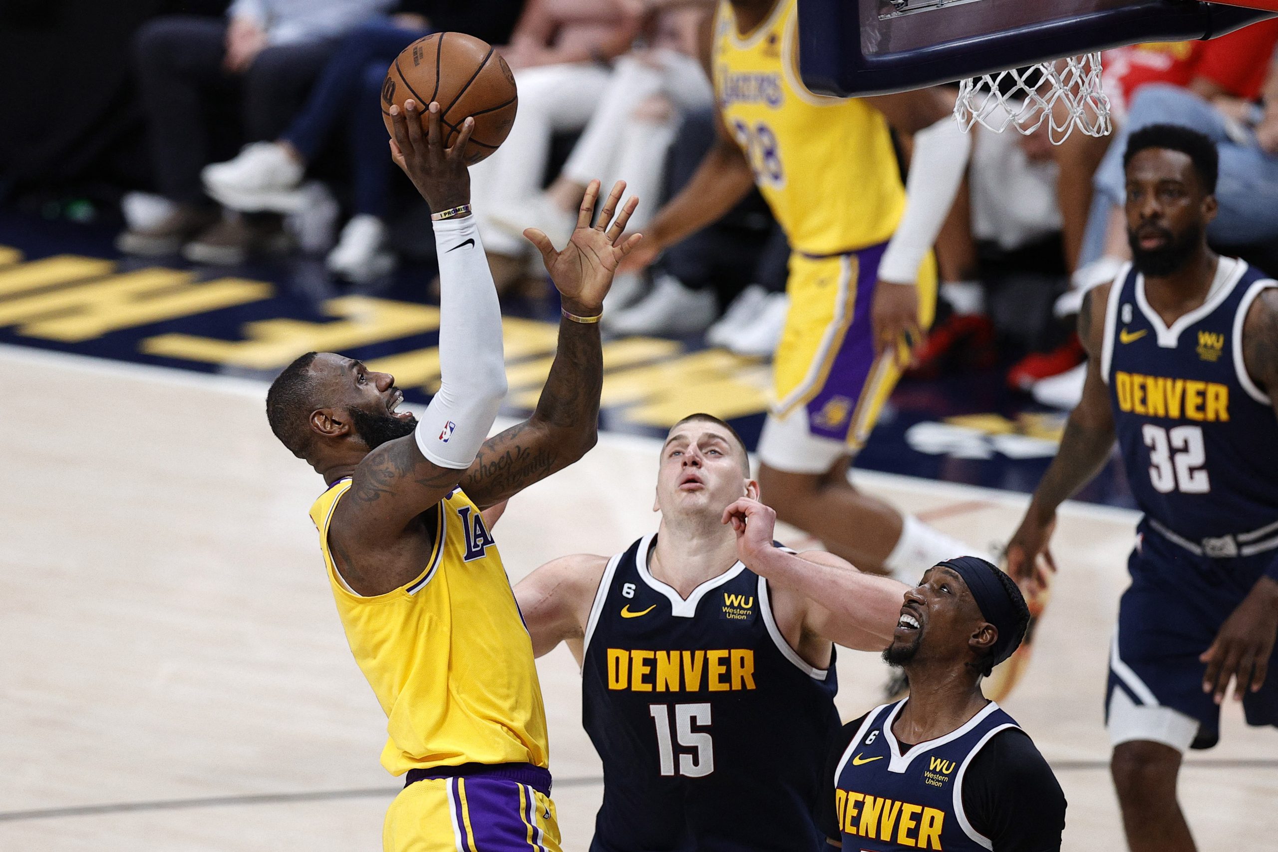 May 18, 2023; Denver, Colorado, USA; Los Angeles Lakers forward LeBron James (6) shoots against Denver Nuggets center Nikola Jokic (15) and guard Kentavious Caldwell-Pope (5) in the third quarter during game two of the Western Conference Finals for the 2023 NBA playoffs at Ball Arena. Mandatory Credit: Isaiah J. Downing-USA TODAY Sports Photo: Isaiah J. Downing/REUTERS