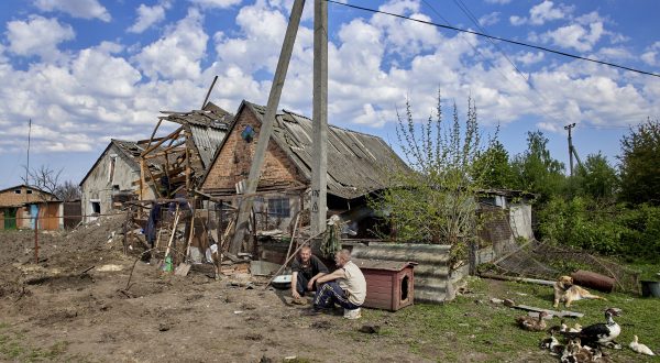 epa10627581 Locals sit next to a damaged building in the aftermath of a rocket attack in the Zolochiv settlement of the Kharkiv's area, Ukraine, 14 May 2023, amid the Russian invasion. Russian troops carried out S-300 missile strikes on Kharkiv and the Zolochiv settlement in the Kharkiv district on the night between 13 and 14 May. Some buildings and a transport infrastructure were damaged, the head of the Kharkiv Regional Civil-Military Administration Oleg Synegubov announced on 14 May. No victims were reported.  EPA/SERGEY KOZLOV