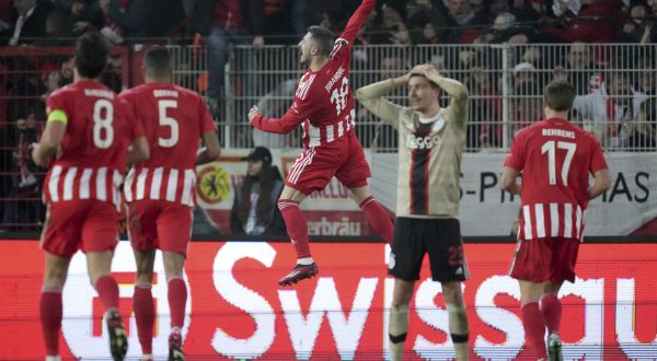 Union's Josip Juranovic, center, celebrates after scoring his side's second goal during the Europa League playoff second leg soccer match between 1. FC Union Berlin and Ajax Amsterdam in Berlin, Germany, Thursday, Feb. 23, 2023. (AP Photo/Michael Sohn)