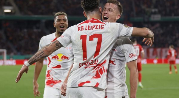 epa10604966 Dominik Szoboszlai of Leipzig celebrates with teammate Daniel Olmo Carvajal (R) after scoring the 0-3 during the DFB Cup semi-final soccer match between SC Freiburg and RasenBallsport Leipzig in Freiburg, Germany, 02 May 2023.  EPA/RONALD WITTEK  ATTENTION:  The DFB regulations prohibit any use of photographs as image sequences and/or quasi-video.