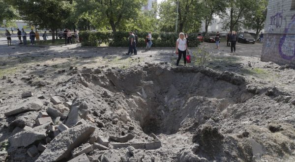 epa10666555 A person stands next to a shell crater near a residential building after a missile strike in Kyiv (Kiev), Ukraine, 01 June 2023, amid the Russian invasion. At least three people died, including a child, and ten others were injured after a missile attack on the Ukrainian capital, the National Police said. Russian troops entered Ukrainian territory in February 2022, starting a conflict that has provoked destruction and a humanitarian crisis.  EPA/SERGEY DOLZHENKO