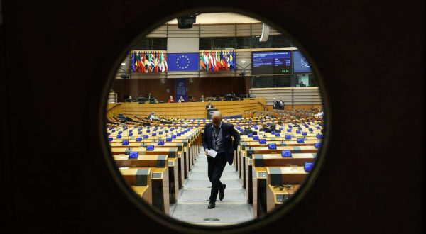 epaselect epa10666398 A view through a bulleye window of the plenary hall's doors during a debate on 'Foreign interference in democratic processes and election integrity' during a mini plenary session of the European Parliament in Brussels, Belgium, 01 June 2023.  EPA/OLIVIER HOSLET