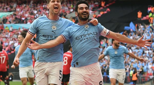 epa10670820 Ilkay Gundogan (R) of Manchester City celebrates with teammate John Stones (L) after scoring the 2-1 goal during the FA Cup final soccer match between Manchester City and Manchester United, in London, Britain, 03 June 2023.  EPA/ANDY RAIN EDITORIAL USE ONLY. No use with unauthorized audio, video, data, fixture lists, club/league logos or 'live' services. Online in-match use limited to 120 images, no video emulation. No use in betting, games or single club/league/player publications.