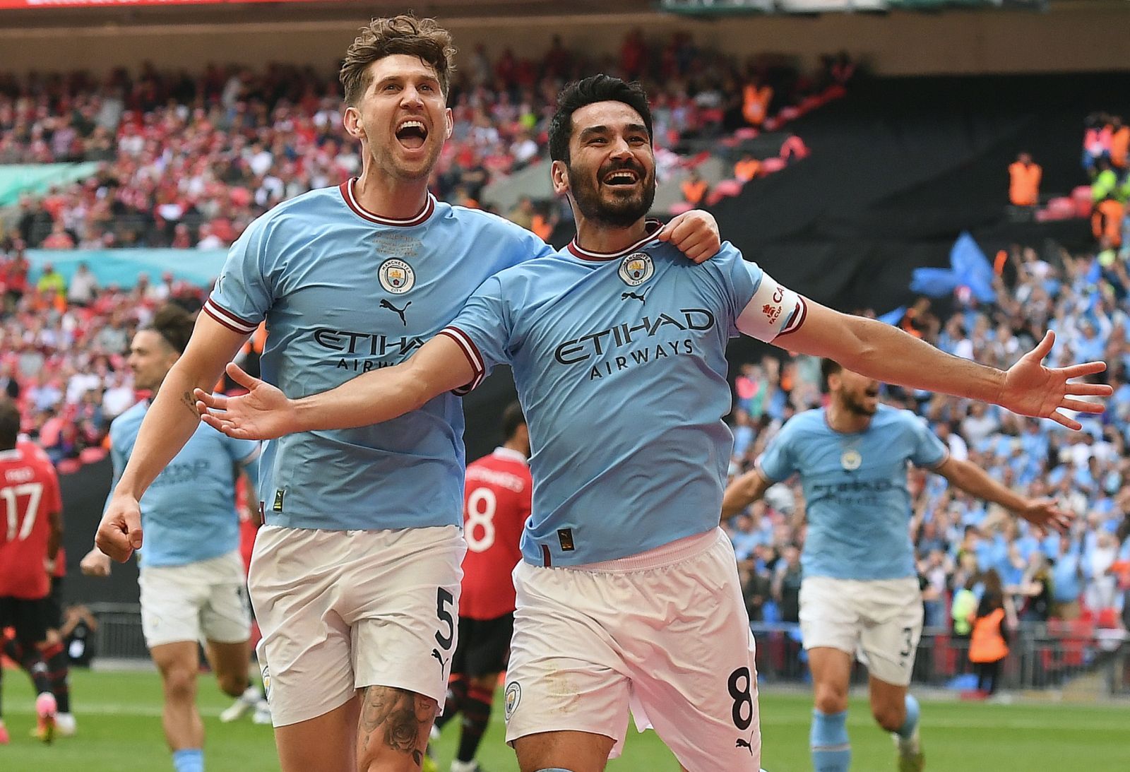 epa10670820 Ilkay Gundogan (R) of Manchester City celebrates with teammate John Stones (L) after scoring the 2-1 goal during the FA Cup final soccer match between Manchester City and Manchester United, in London, Britain, 03 June 2023.  EPA/ANDY RAIN EDITORIAL USE ONLY. No use with unauthorized audio, video, data, fixture lists, club/league logos or 'live' services. Online in-match use limited to 120 images, no video emulation. No use in betting, games or single club/league/player publications.
