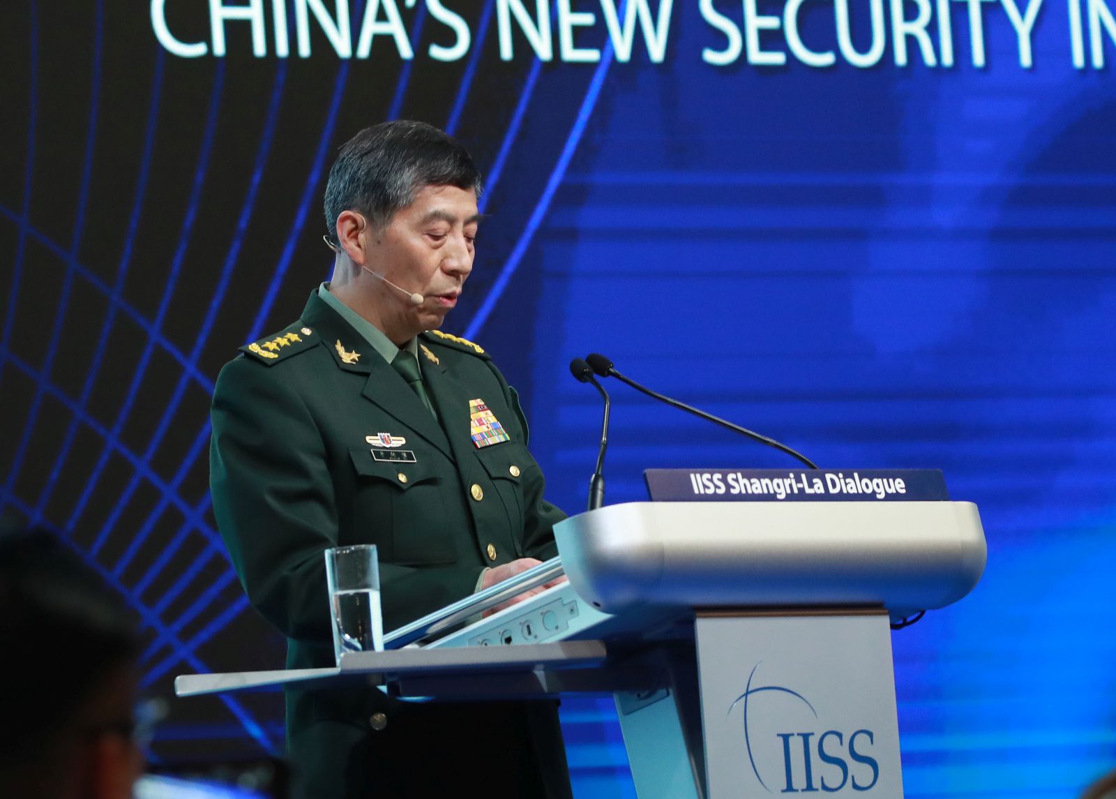 epa10671809 Chinese State Councilor and Minister of National Defence General Li Shangfu delivers his speech during a plenary session of the International Institute for Strategic Studies (IISS) Shangri-la Dialogue at the Shangri-la hotel in Singapore, 04 June 2023. Defense ministers and officials from 41 countries are gathered in the city state for the IISS Shangri-la Dialogue, an annual high level defence summit in the Asia Pacific region.  EPA/HOW HWEE YOUNG