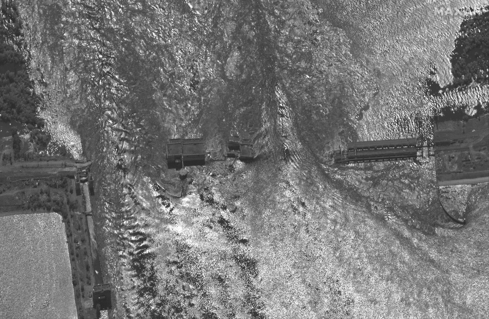 epa10676608 A handout satellite image made available by Maxar Technologies shows a closer view of the destroyed Nova Kakhovka dam and hydroelectric plant in the Kherson region, southern Ukraine, 06 June 2023. Ukraine has accused Russian forces of destroying a critical dam and hydroelectric power plant on the Dnipro River in the Kherson region along the front line in southern Ukraine on 06 June. A number of settlements were completely or partially flooded, Kherson region governor Oleksandr Prokudin said on telegram. Russian troops entered Ukraine on 24 February 2022 starting a conflict that has provoked destruction and a humanitarian crisis.  EPA/MAXAR TECHNOLOGIES HANDOUT -- MANDATORY CREDIT: SATELLITE IMAGE 2023 MAXAR TECHNOLOGIES -- THE WATERMARK MAY NOT BE REMOVED/CROPPED -- HANDOUT EDITORIAL USE ONLY/NO SALES