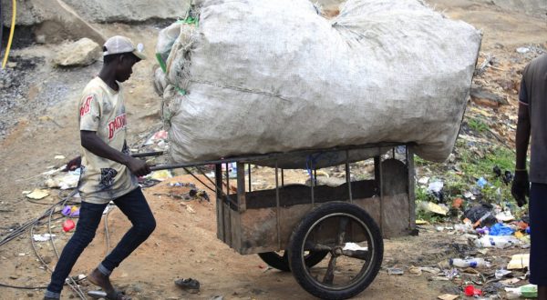 epa10674777 A man pushes a cart loaded with a sack filled up with used plastics for recycling, at a dumpsite along the Lagos-Ibadan expressway in Lagos, Nigeria, 05 June 2023. The World marks the 2023 Environment Day on 05 June with a focus on 'solutions to plastic pollution'.  EPA/AKINTUNDE AKINLEYE  ATTENTION: This Image is part of a PHOTO SET