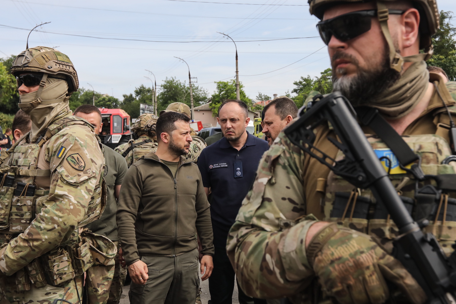 epa10679117 Ukrainian President Volodymyr Zelensky (C-L) visits Kherson, Ukraine, 08 June 2023, amid the Russian invasion. Ukraine has accused Russian forces of destroying a critical dam and hydroelectric power plant on the Dnipro River in the Kherson region along the front line in southern Ukraine on 06 June, leading to the flooding of a number of settlements.  EPA/MYKOLA TYMCHENKO