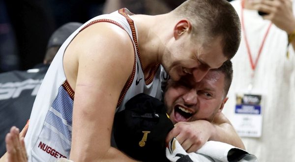 epa10687805 Denver Nuggets center Nikola Jokic of Serbia (L) is congratulated by family following the Nuggets win over the Miami Heat to win the NBA championships at Ball Arena in Denver, Colorado, USA, 12 June 2023.  EPA/JOHN G. MABANGLO  SHUTTERSTOCK OUT