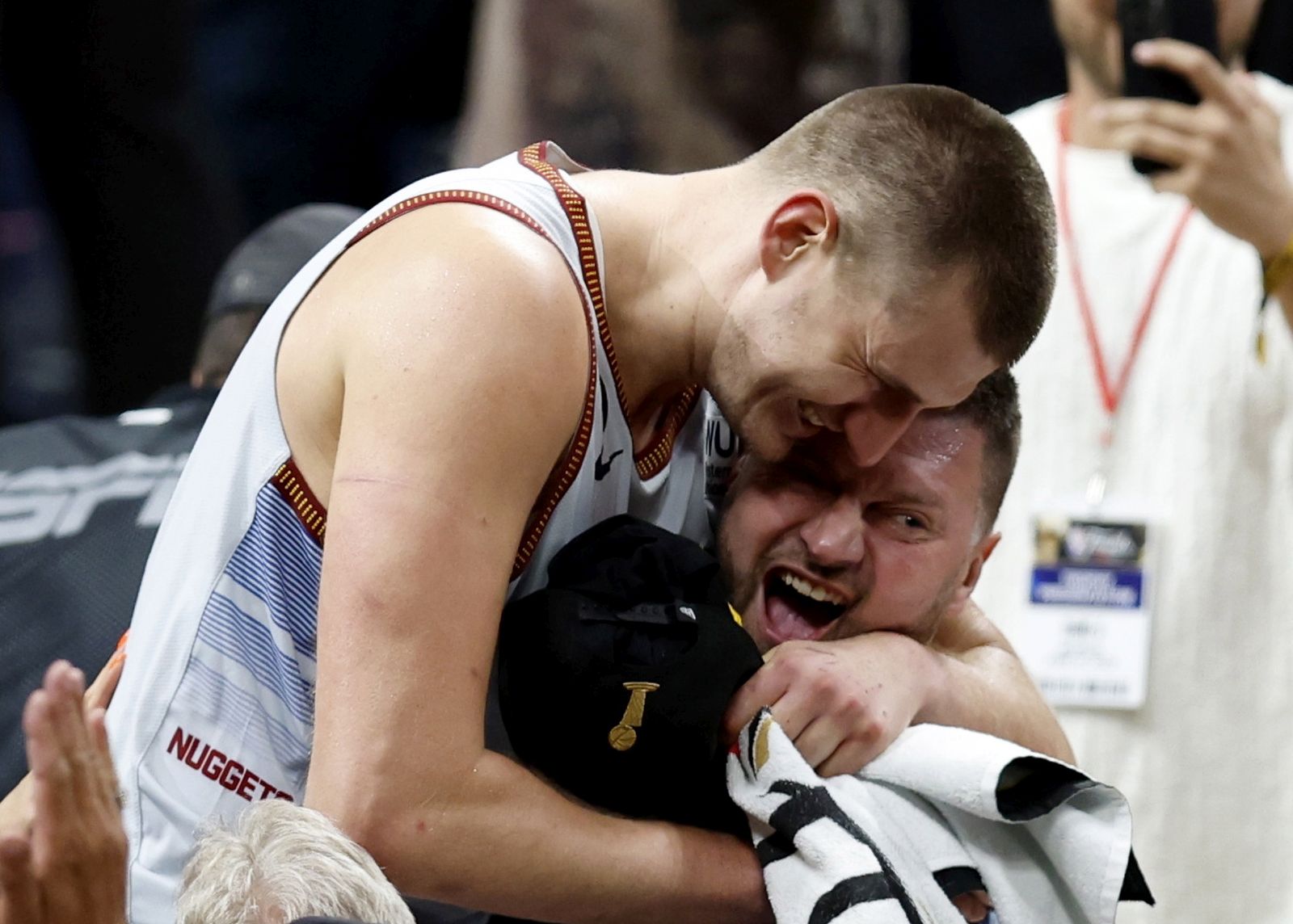 epa10687805 Denver Nuggets center Nikola Jokic of Serbia (L) is congratulated by family following the Nuggets win over the Miami Heat to win the NBA championships at Ball Arena in Denver, Colorado, USA, 12 June 2023.  EPA/JOHN G. MABANGLO  SHUTTERSTOCK OUT