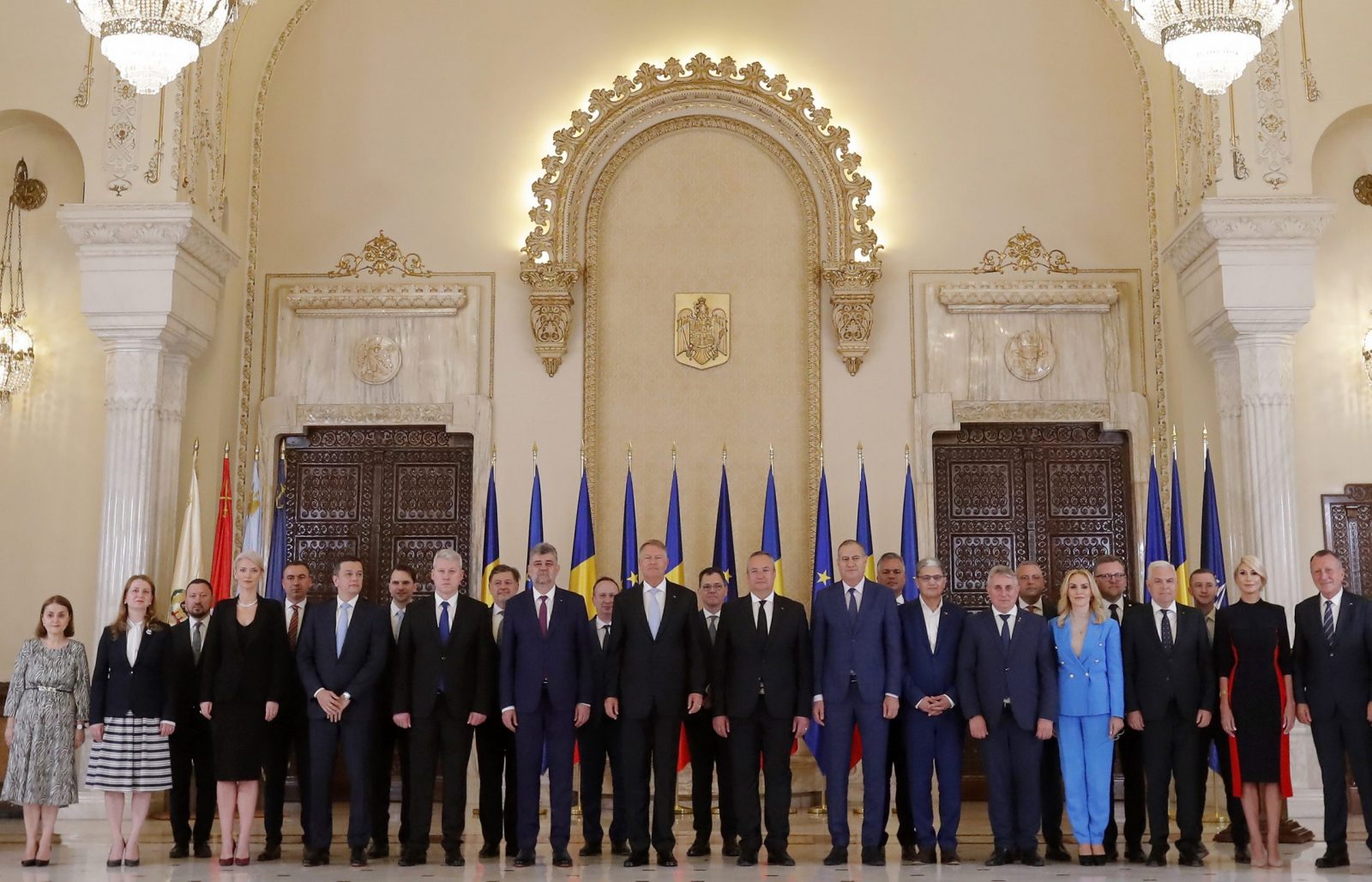 epa10692866 Romania's new Prime Minister Marcel Ciolacu (C-L), Senate's President Nicoale Cicua (C-R), Romania's President Klaus Iohannis (C, with grey tie) and all cabinet members pose for a group photo after the swearing in ceremony held at the Presidential Palace in Bucharest, Romania, 15 June 2023. Romanian President Iohannis announced on 13 June that he appointed PSD (Social Democratic Party) party leader Marcel Ciolacu as prime minister-designate to form a new government team. The ruling coalition (National Coalition for Romania) formed by the PSD (Social Democratic Party), PNL (National Liberal Party) and UDMR (Democratic Alliance of Hungarians in Romania) parties in 2021 agreed a political protocol to rule by rotating the Prime Ministers. Leader of the Social Democratic Party Marcel Ciolacu was until now the President of the Chamber of Deputies of the Romanian Parliament. Ciolacu's cabinet passed the confidence vote with 290 ballots, the minium requirement being 234 for passing.  EPA/ROBERT GHEMENT