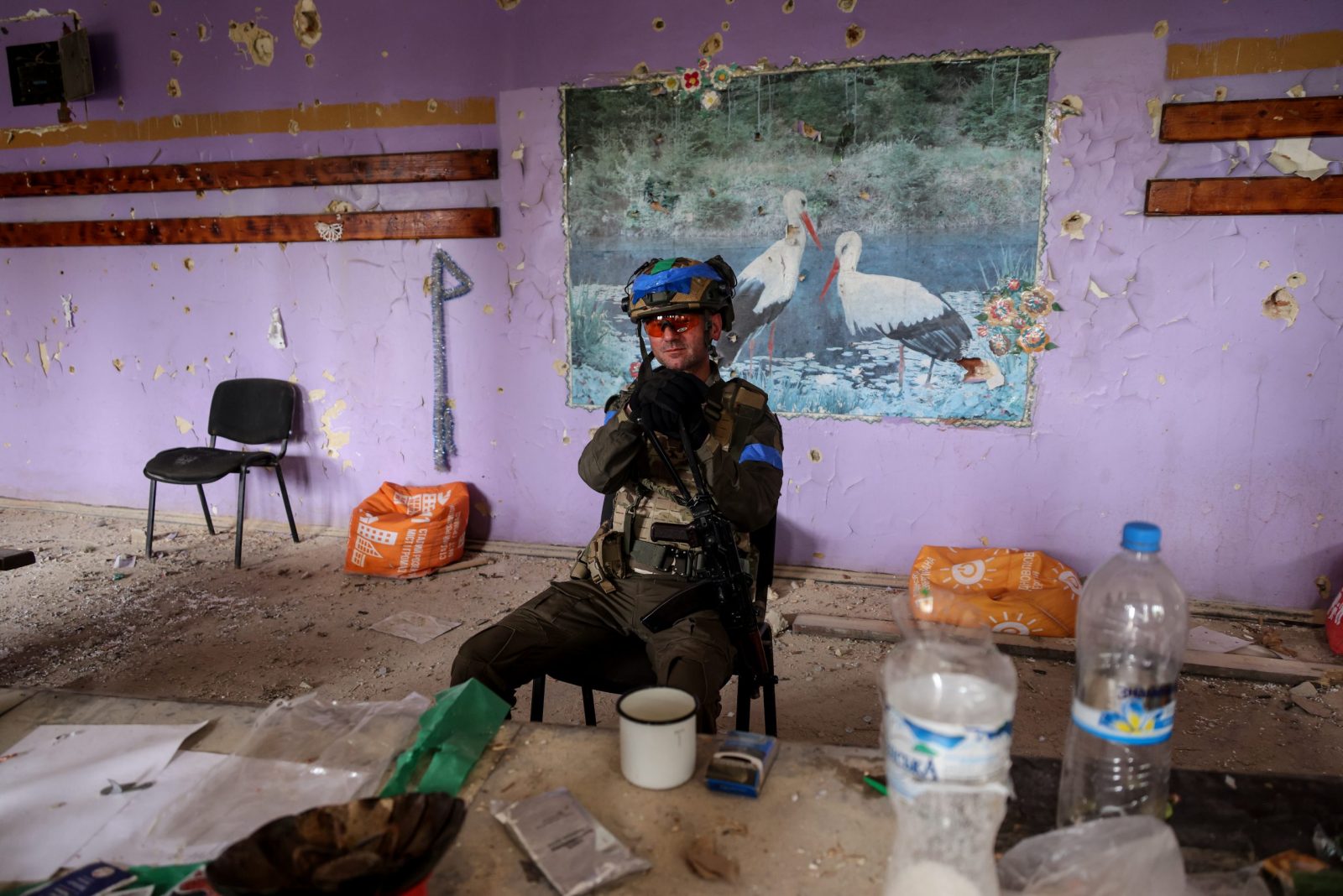 epa10696720 A Ukrainian serviceman of the 688th Separate Jager Infantry Brigade 'Oleksa Dovbush' sits inside a damaged building in the recently recaptured village of Blahodatne, Donetsk region, Ukraine, 17 June 2023. Russian troops entered Ukraine in February 2022 starting a conflict that has provoked destruction and a humanitarian crisis.  EPA/STRINGER