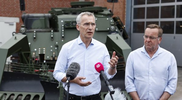 epa10701739 NATO Secretary General Jens Stoltenberg (L) and German Defence Minister Boris Pistorius speak to the media while standing in front of a mine clearance tank Wisent at FFG Flensburger Fahrzeugbau Gesellschaft in Flensburg, Germany, 20 June 2023 . FFG is a private company that is refurbishing Leopard 1 tanks that are being donated by NATO member countries to Ukraine.  EPA/MORRIS MACMATZEN / POOL