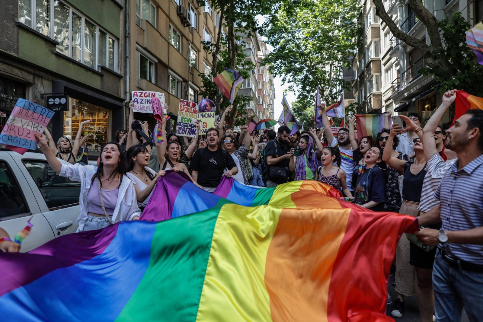 epa10710757 LGBT (lesbian, gay, bisexual, transgender) community members and supporters hold rainbow-colored flags and shout slogans during the Pride March in Istanbul, Turkey, 25 June 2023. The Turkish Government has banned the Istanbul Pride March as they already did in previous years.  EPA/ERDEM SAHIN