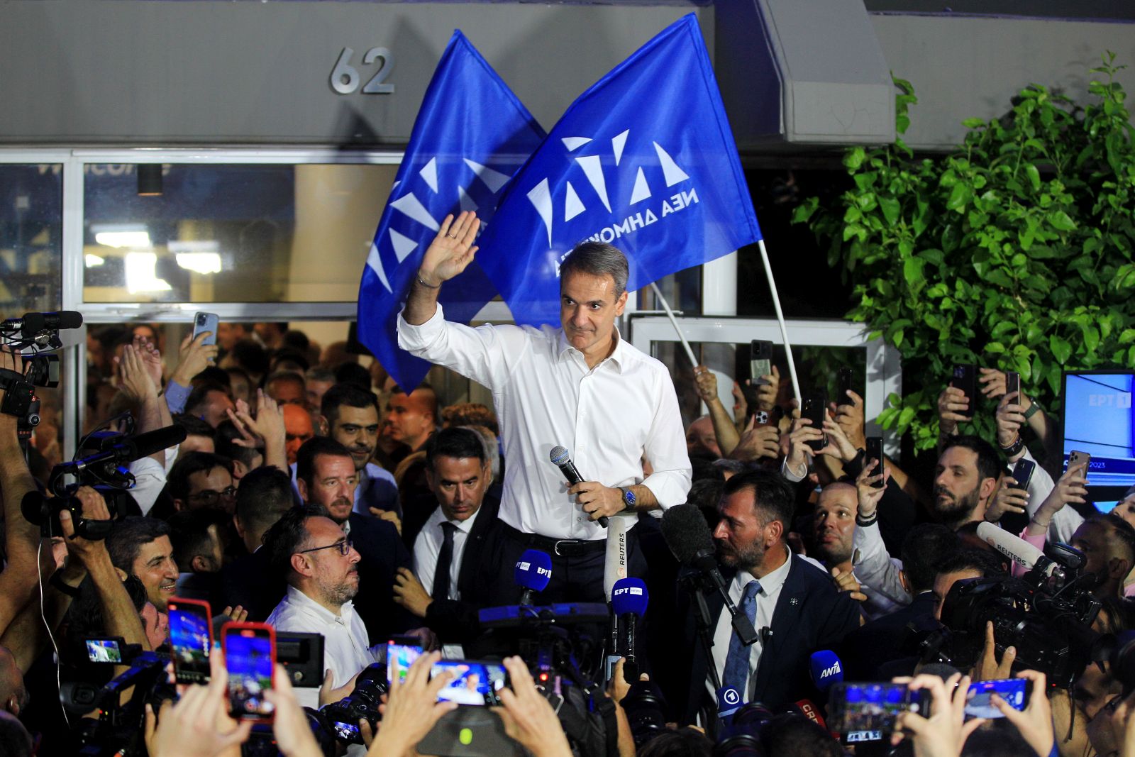 epa10711323 Leader of New Democracy political party Kyriakos Mitsotakis (C) greets supporters after the announcement of the first results in the Greek general elections, at the party's headquarters, in Athens, Greece, 25 June 2023. With nearly 90 percent of the votes counted, New Democracy will form a stand-alone government for a second term with 158 seats in a 300-seat Parliament and 40.51 percent of the votes, followed by SYRIZA with 47 (17.84 percent) and PASOK-KINAL with 32 seats (11.97 percent). Greece held its second general election in five weeks on June 25, after current Prime Minister Mitsotakis won the May 2023 elections but fell short of enough seats in parliament to form a government.  EPA/ALEXANDROS VLACHOS