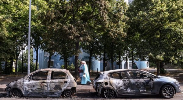 epa10715187 People walk past burnt out car on avenue Pablo Picasso following a night of civil unrest, in Nanterre, near Paris, France, 28 June 2023. The violence broke out after police fatally shot a 17-year-old during a traffic stop in Nanterre. According to the French interior minister, 31 people were arrested with 2,000 officers being deployed to prevent further violence.  EPA/Mohammed Badra