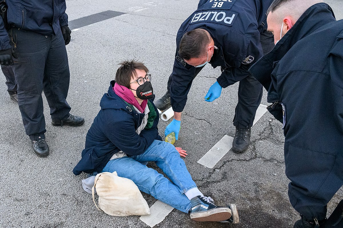 Lina Eichler hat sich an der Ausfahrt von der A100 festgeklebt und die Hand wird von der Polizei gelöst. Berlin, 31.01.22