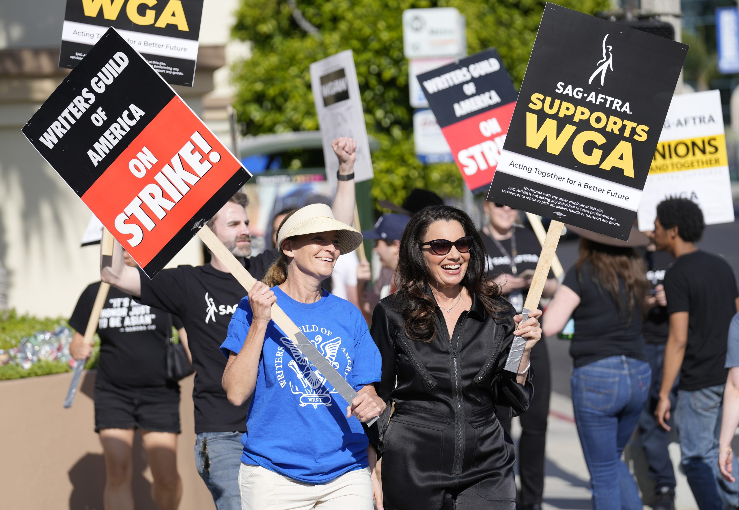 FILE - Meredith Stiehm, left, president of Writers Guild of America West, and Fran Drescher, president of SAG-AFTRA, take part in a rally by striking writers outside Paramount Pictures studio in Los Angeles on May 8, 2023. Hollywood actors may be on the verge of joining screenwriters in what would be the first two-union strike in the industry in more than six decades. (AP Photo/Chris Pizzello, File)
