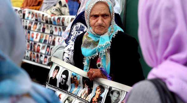 epa10685031 Women from Srebrenica hold banners showing pictures of the 1995 Srebrenica massacre, during a peaceful demonstration at Alija Izetbegovic Square in Zenica, Bosnia and Herzegovina, 11 June 2023. More than 8,000 Muslim men and boys were executed in July 1995 after Bosnian Serb forces overran the town of Srebrenica during the Bosnian War. The protest takes place every 11th of the month across different cities of Bosnia and Herzegovina.  EPA/FEHIM DEMIR