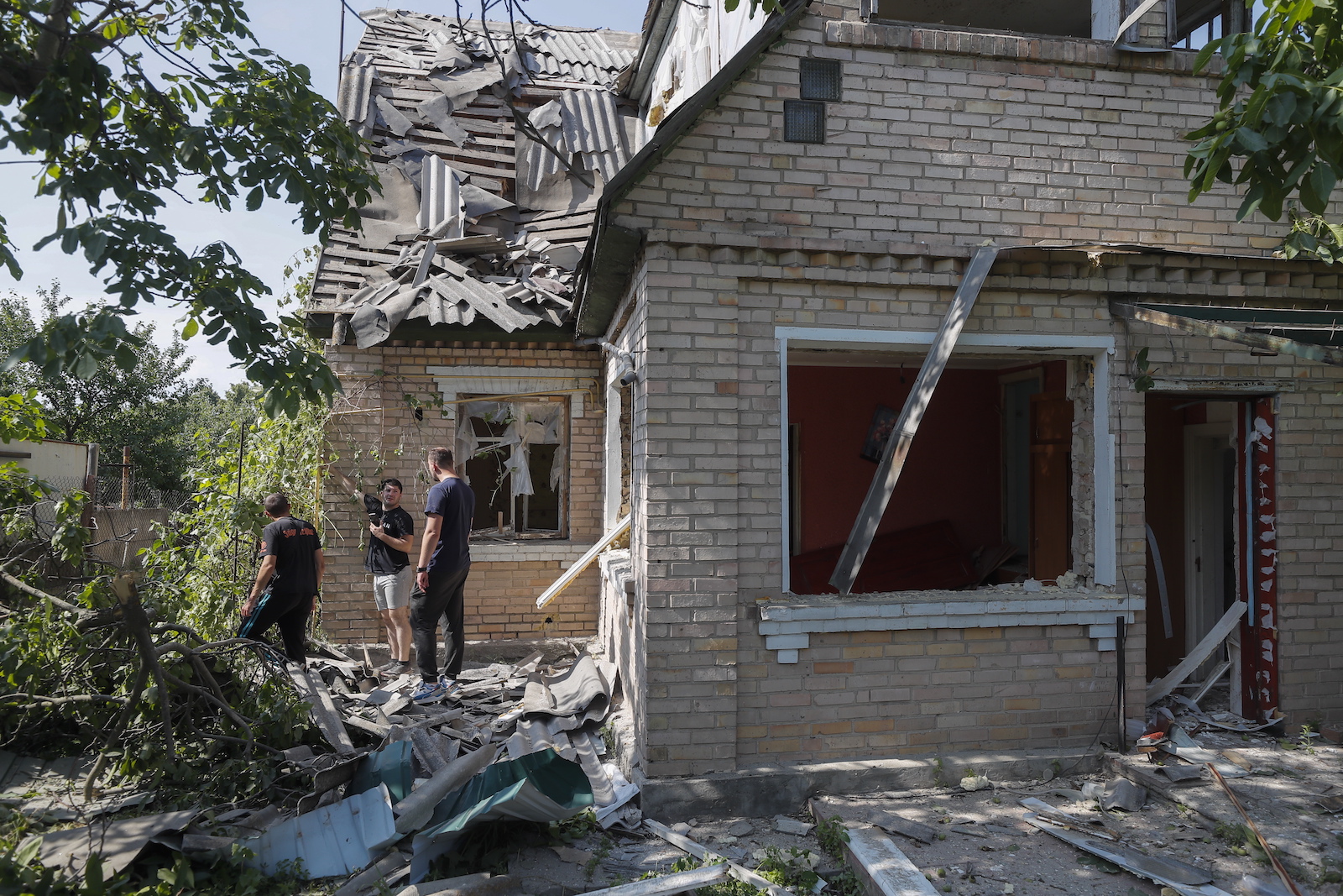 epa10695222 Residents inspect the damage to their home at the site hit by falling debris from a rocket, in Stari Petrivtsi village near Kyiv (Kiev), Ukraine, 16 June 2023, amid Russia's invasion. Ukraine Air Force reported 16 June, that Russia fired six Kh-47M2 Kinzhal, six Kalibr missiles and two reconnaissance drones on Kyiv. All air targets were shot down according to their report. As State Emergency Service reported, three private buildings were destroyed, 15 were damaged. At least three people were injured including one child. Russian troops entered Ukrainian territory in February 2022, starting a conflict that has provoked destruction and a humanitarian crisis.  EPA/SERGEY DOLZHENKO