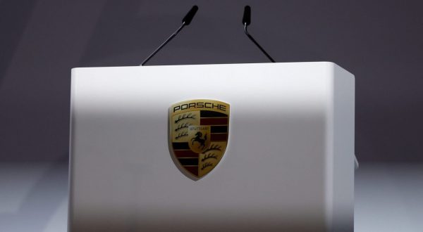 epa10714952 The logo of Porsche pictured at the rostrum during the annual general meeting of Porsche AG in Stuttgart, Germany, 28 June 2023.  EPA/RONALD WITTEK