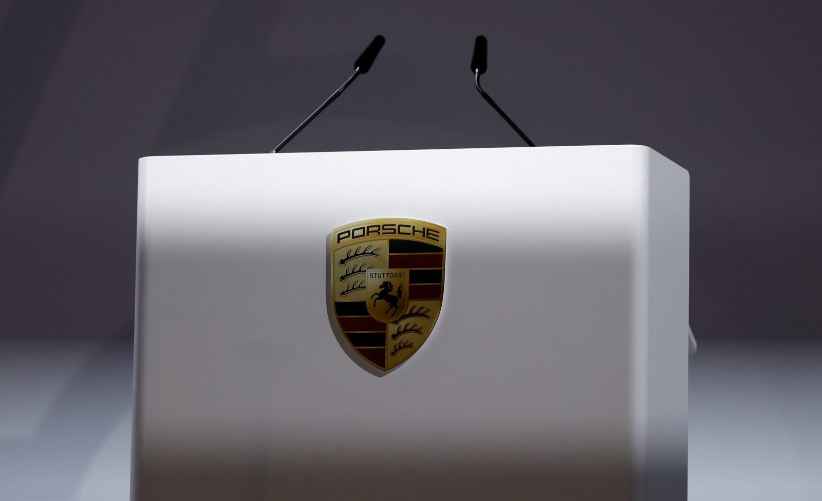 epa10714952 The logo of Porsche pictured at the rostrum during the annual general meeting of Porsche AG in Stuttgart, Germany, 28 June 2023.  EPA/RONALD WITTEK