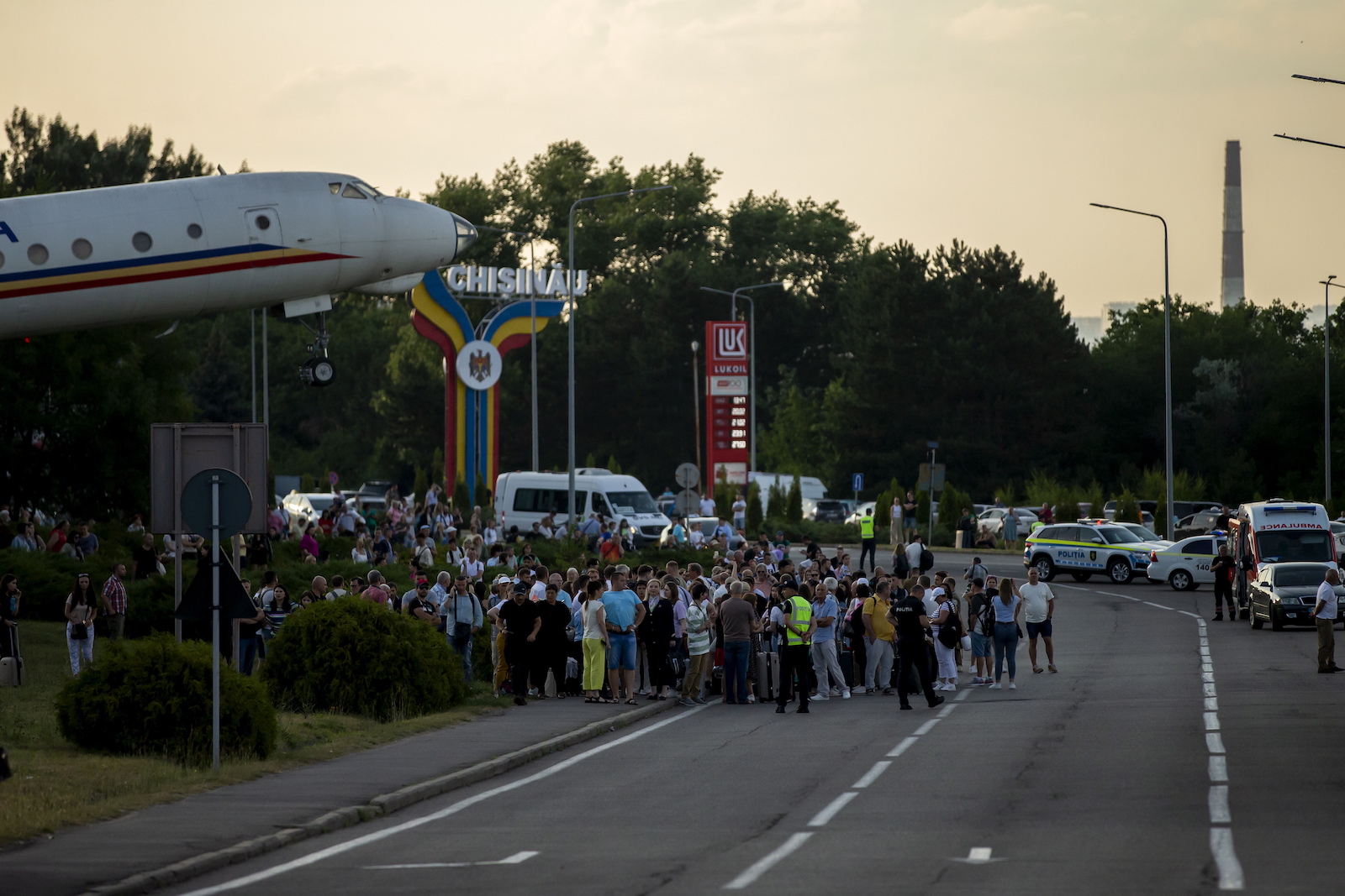epa10720014 Passengers are evacuated outside the terminal of the Chisinau International Airport in Chisinau, Moldova, 30 June 2023. Moldovan Foreign Ministry informed that two people were killed in a shooting in a terminal building of the airport. The suspect shooter is detained, local Police spokeswoman said. All the flights from the Chisinau Airport are delayed.  EPA/DUMITRU DORU