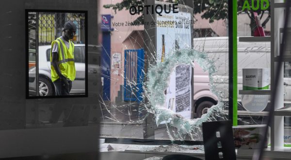 epa10720395 A person inspects a damaged establishment following a night of looting and rioting in Montreuil, near Paris, France, 01 July 2023. Violence broke out across France over the fatal shooting of a 17-year-old teenager by a police officer during a traffic stop in Nanterre on 27 June.  EPA/JULIEN MATTIA